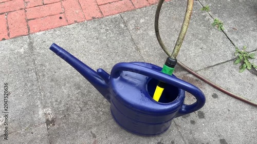 Filling a garden watering can