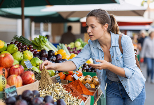 Young Woman Buying Spices at Local Farmers Market