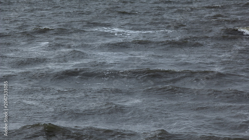Obraz na plátně Wind‑driven ripples forming shifting patterns on dark open water