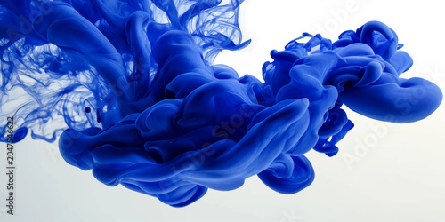 Bild auf Leinwand An abstract blue liquid and purple smoke pattern creates a beautiful flower shap