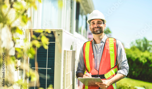 technician working on air conditioning or heat pump outdoor unit inspection or repair
