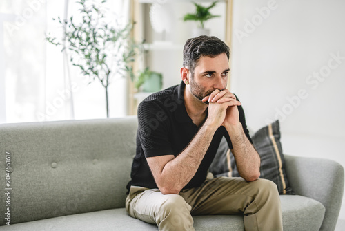 Stressed unhappy young 30s man lost in negative thoughts, having problems in personal life situation