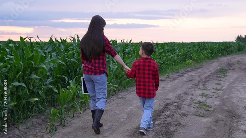 mother child holding hands, happy people woman child, Journey through nature with family, Little boy guided by his mom, Mother and son on a dirt road, Experiences in rural America, Farm life