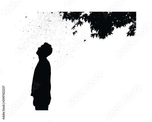Silhouette of a person with leaves and debris blowing away from head outside