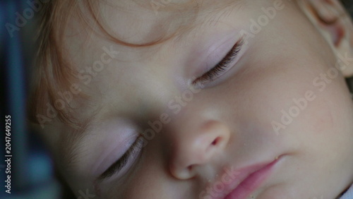 Fotografie Close up portrait of sleeping toddler face capturing peaceful rest, innocence an
