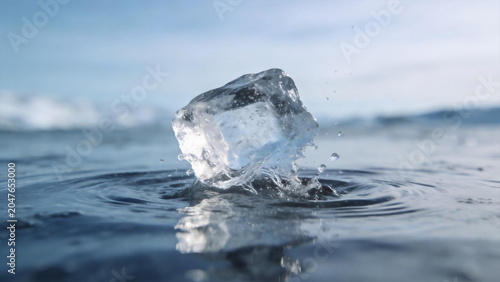 Ice cube splashing into water