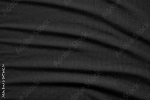 Close up black wrinkled fabric texture rippled surface, Soft focus.