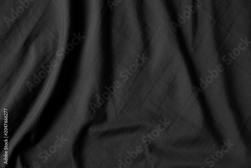 Close up black wrinkled fabric texture rippled surface, Soft focus.