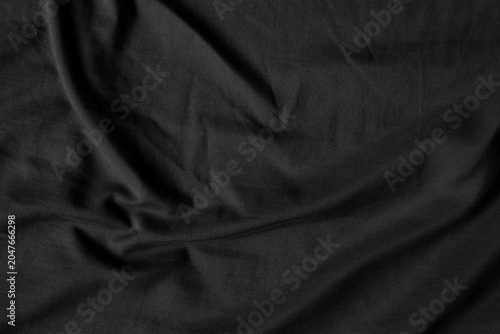 Close up black wrinkled fabric texture rippled surface, Soft focus.