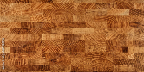 Close-up of a wooden cutting board with a rich, grainy texture and warm, natural tones, showcasing intricate wood grain patterns.
