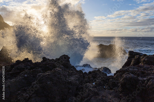 Powerful Atlantic Wave Crashing Against Volcanic Rocks at Sunset