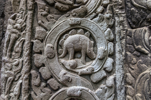 Photos Detailed stone relief carving resembling a stegosaurus dinosaur on Ta Prohm temp