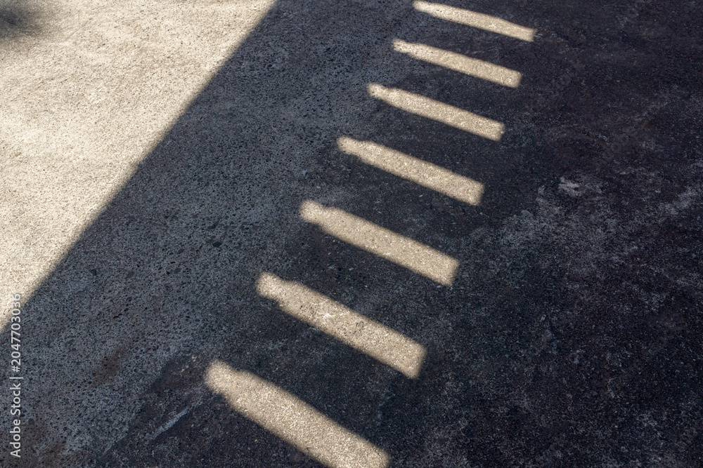 Fototapeta premium Shadow Pattern From Wall Openings on Rough Concrete Surface Background
