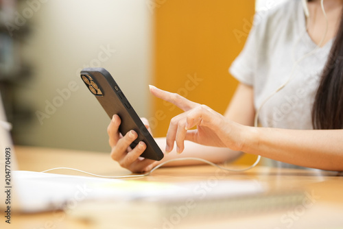 Photos A close-up of a person using a smartphone to browse content or apps
