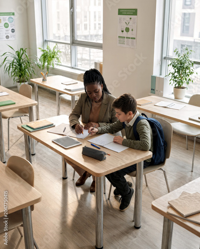 Teacher Assisting Student During Individual Learning Session