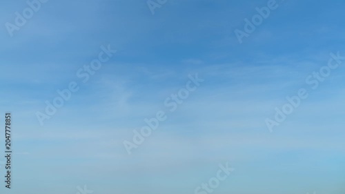 Blue sky with light soft clouds, time lapse. Clear day atmosphere with bright horizon. Sunny weather background for outdoor concept. Meteorological view of upper atmosphere for nature design.