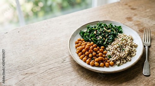 Roasted chickpeas kale and quinoa bowl on a wooden table
