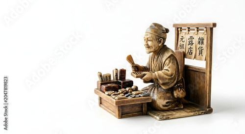 Traditional artisan figurine sculpting items at a wooden table  