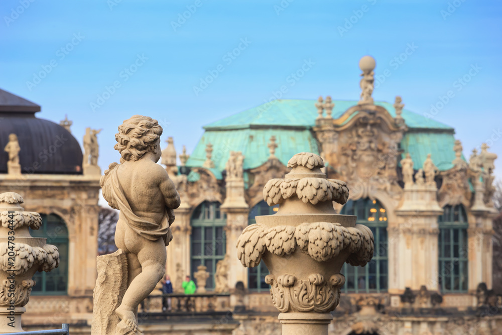 Obraz premium Cityscape - view of the balustrade with sculptures of vases and cupids of the Zwinger palatial complex in Dresden, Saxony, Germany