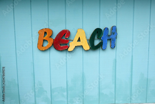 Εκτύπωση καμβά Multicolored letters spelling BEACH are affixed to a light blue wooden wall