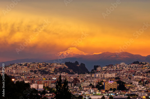 Cayambe Volcano, snow-capped at sunset over the Quito skyline, Ecuador