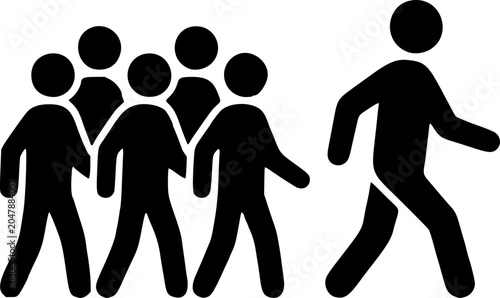 Fotografie A group of people walking together with one individual standing out running alone in the opposite direction