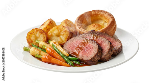Traditional roast beef dinner with Yorkshire pudding, roasted potatoes and glazed vegetables, gourmet sliced medium-rare beef roast on a white plate isolated PNG with Transparent Background