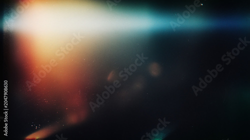 blurred light effects with dark background and colorful light flares, digital abstract background for design