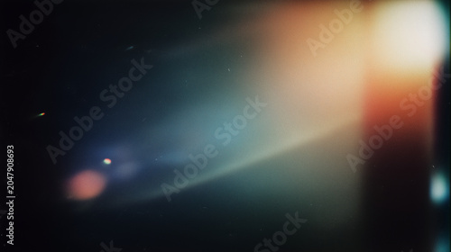 abstract colorful light leaks and bokeh effect on dark background background