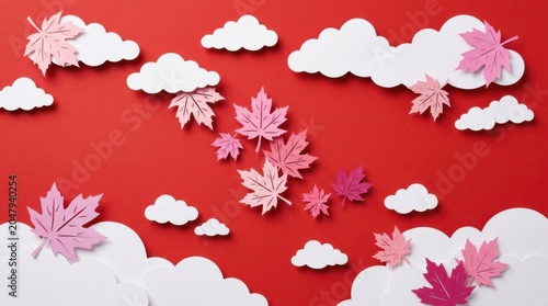 Pink and white paper cutouts of leaves and clouds on red