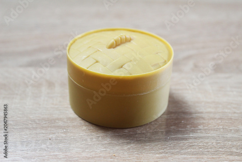 Yellow box with a squishy dumpling on a light background