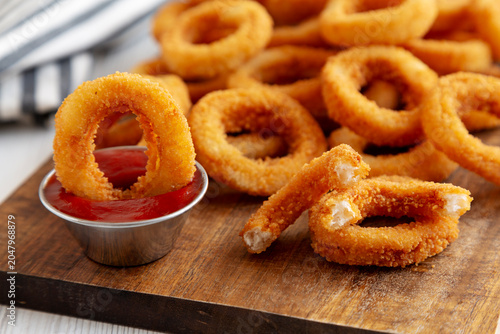 Homemade Fried Onion Rings with Ketchup, side view. Close-up.