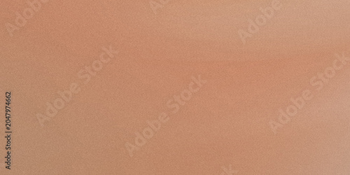 A close up view of a smooth textured surface with a warm terracotta or light peach color tone.