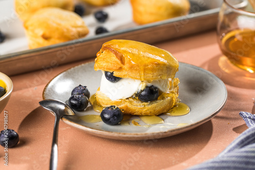 Scone Filled with Blueberry  and Clotted Cream on a plate