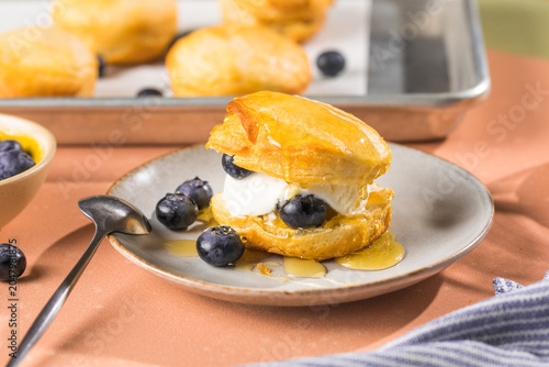 Scone Filled with Blueberry  and Clotted Cream on a plate