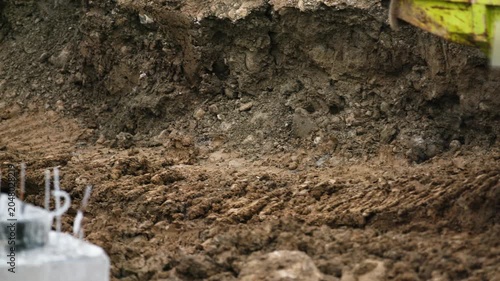 Tracked Dumper Undercarriage Moving Through Muddy Construction Site