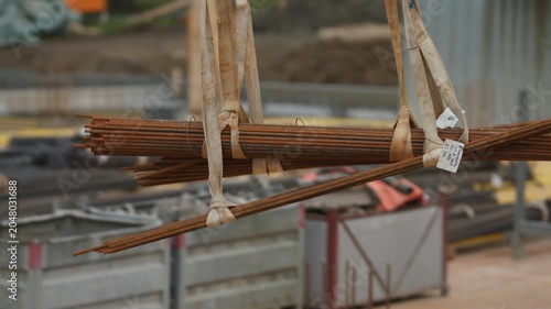 Suspended Rebar Bundle Transported by Crane at Construction Site