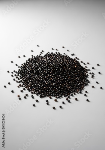 Detailed view of raw black quinoa grains styled on a minimalist surface, ideal for wholesome vegan and healthy culinary meal preparations, culinary, healthy, raw