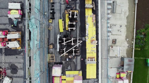 Top-Down Drone View of Active Construction Site with Building Materials