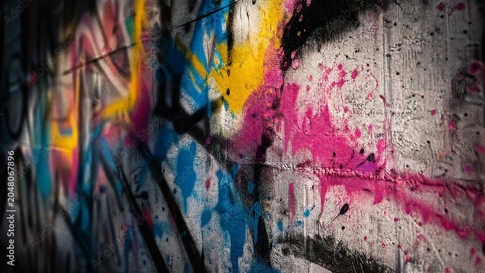 Obraz premium Urban wall adorned with vibrant paint splatters, embodying abstract street art energy.