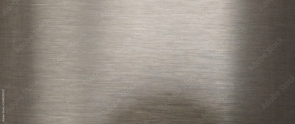 Fototapeta premium Brushed Metallic Background Texture with Subtle Horizontal Lines and Diffused Light Reflections Creating a Smooth Gradient Industrial Surface