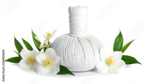 A white herbal compress rests with jasmine flowers and leaves, creating a soothing composition, on a pristine white background