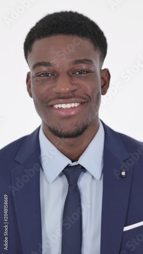 African Businessman Smiling at Camera on White Background, Vertical Video