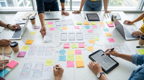 Obraz na płótnie Team of designers collaborating on mobile app interface wireframes
