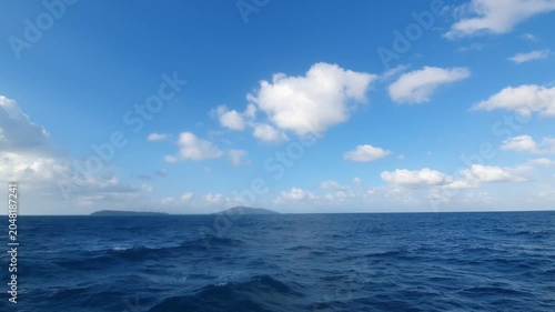 various shapes of clouds in the sky above the choppy sea