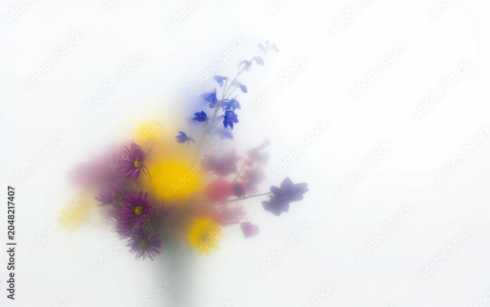 Obraz premium Abstract floral background with colorful flowers behind frosted glass