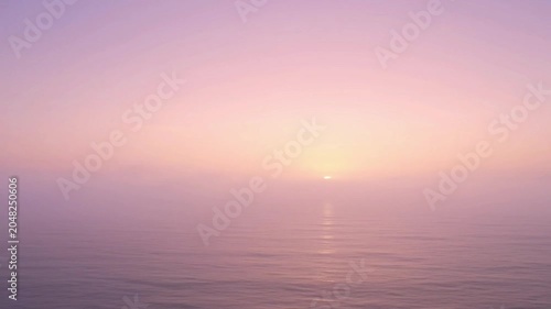 Sunset over calm ocean water.