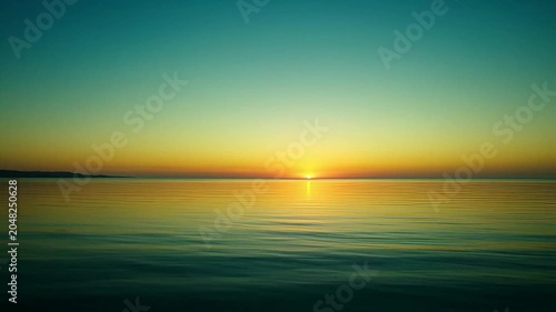 Sunset over calm ocean water.
