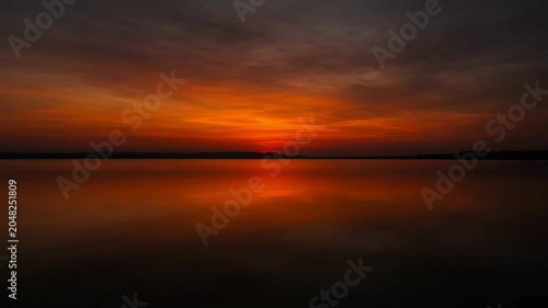 Sunset over calm sea water.