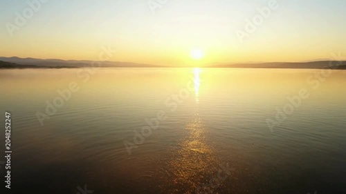 Sunset over calm water body.